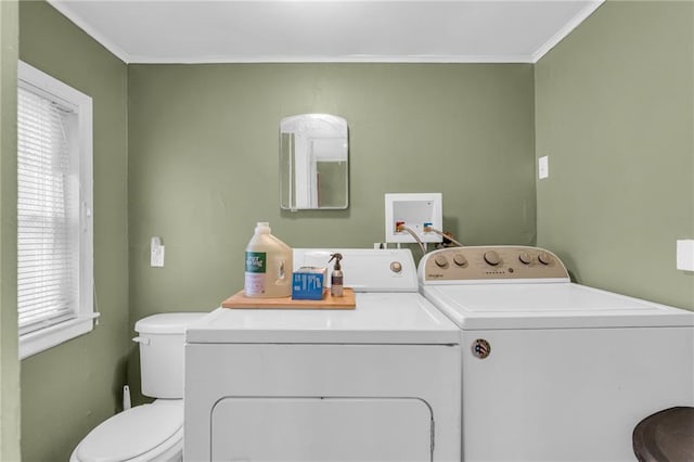 washroom featuring independent washer and dryer, crown molding, and a healthy amount of sunlight