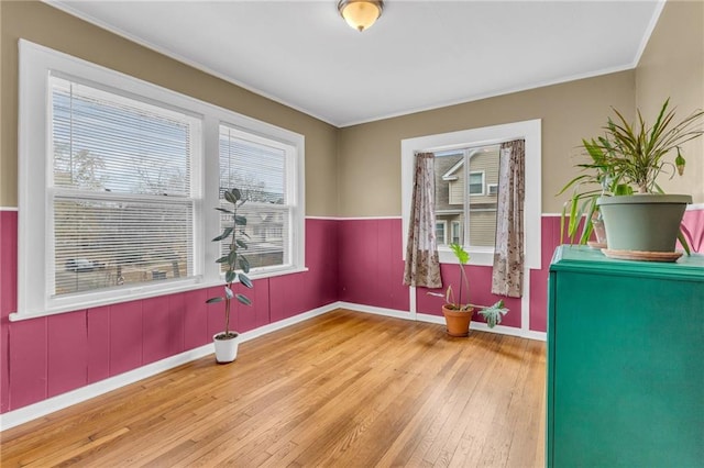 interior space featuring hardwood / wood-style flooring, ornamental molding, and a wealth of natural light