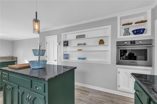 kitchen with hardwood / wood-style floors, a center island, green cabinetry, and stainless steel oven