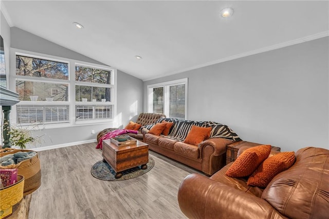 living room featuring ornamental molding, light hardwood / wood-style flooring, and lofted ceiling