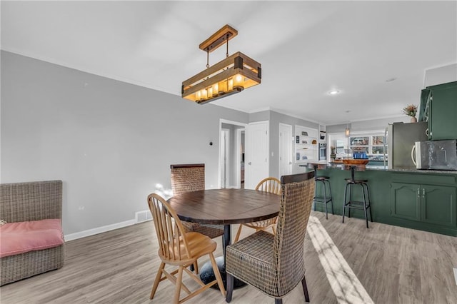 dining room with light hardwood / wood-style flooring