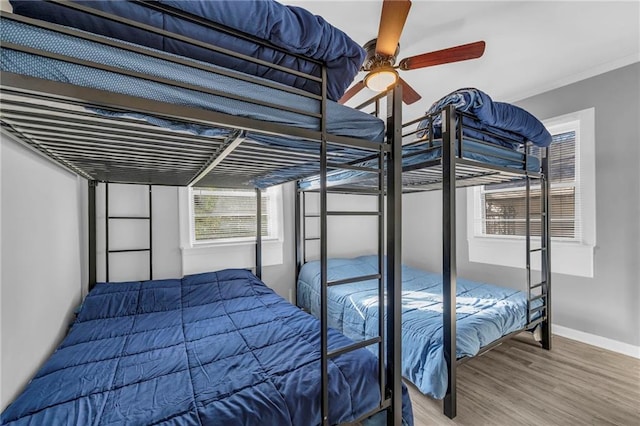 bedroom with hardwood / wood-style flooring and ceiling fan