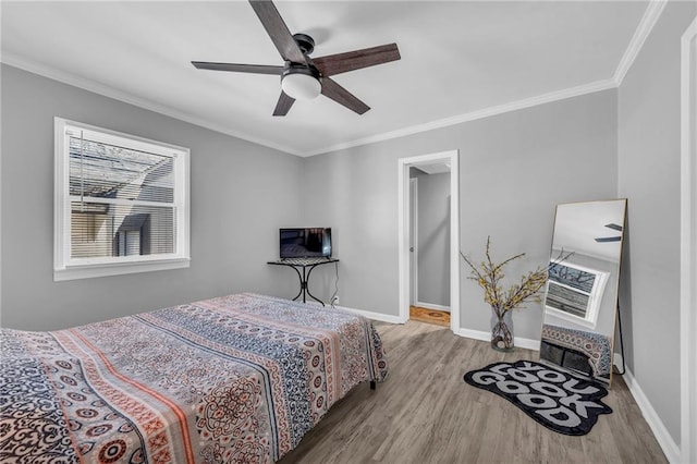 bedroom featuring hardwood / wood-style floors, ceiling fan, and ornamental molding