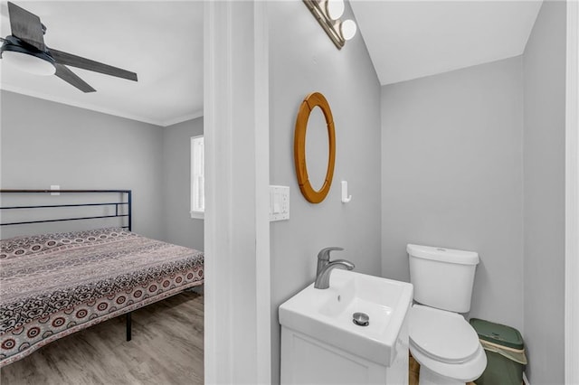 bathroom featuring hardwood / wood-style flooring, toilet, ceiling fan, and sink