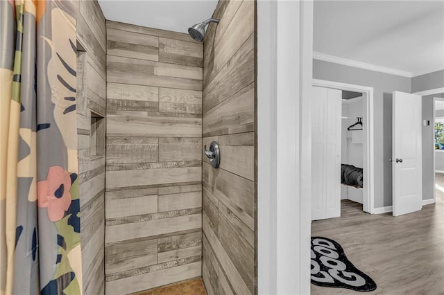 bathroom with curtained shower, ornamental molding, and hardwood / wood-style flooring