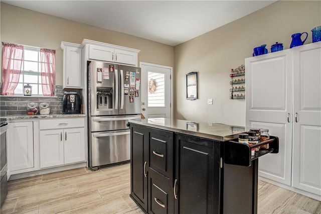 kitchen featuring a center island, white cabinetry, light hardwood / wood-style floors, backsplash, and stainless steel fridge with ice dispenser