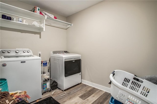 washroom featuring light wood-type flooring and separate washer and dryer