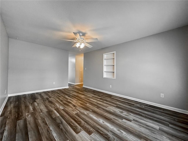 unfurnished room with ceiling fan, dark wood-type flooring, and a textured ceiling