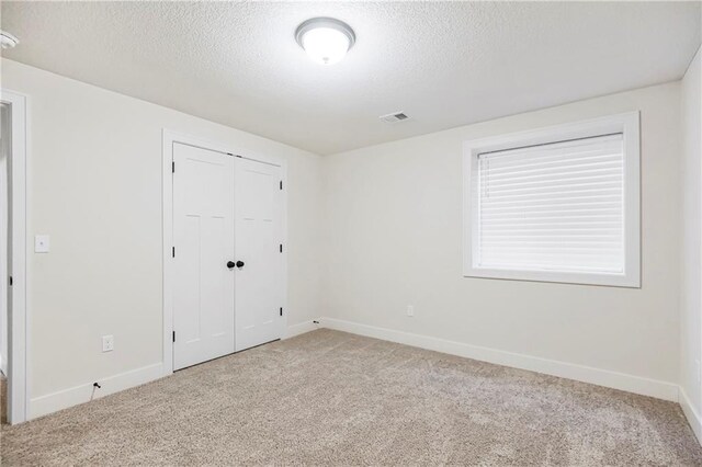 20915 W 190th Ter, Spring Hill, KS 66083 - unfurnished bedroom featuring carpet floors, a textured ceiling, baseboards, and a closet