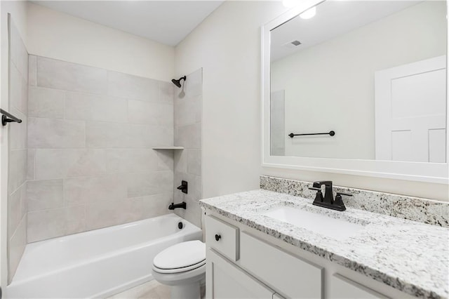 full bathroom featuring vanity, toilet, and tiled shower / bath