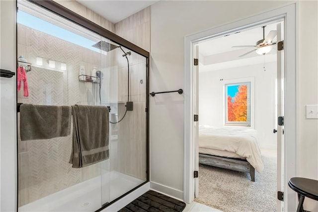 bathroom featuring ceiling fan and a shower with shower door