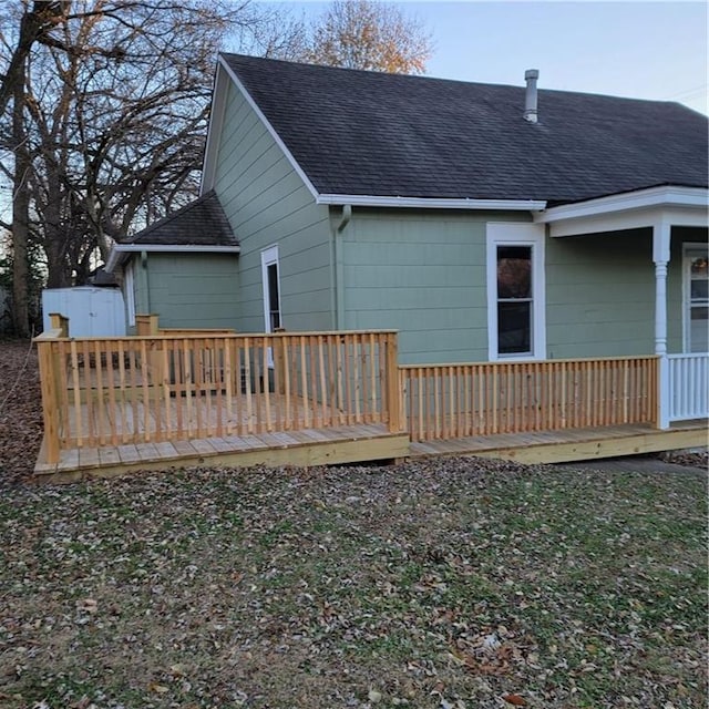 back of property with a wooden deck