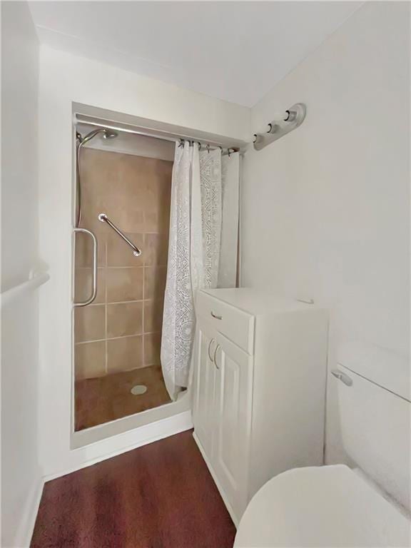 bathroom featuring curtained shower and toilet