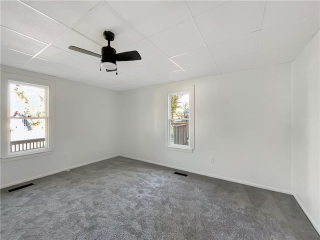 carpeted spare room featuring ceiling fan