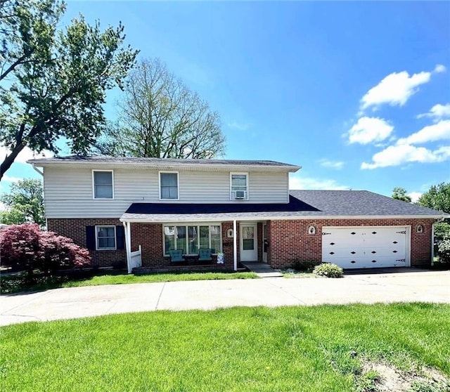 view of front property with a front yard and a garage