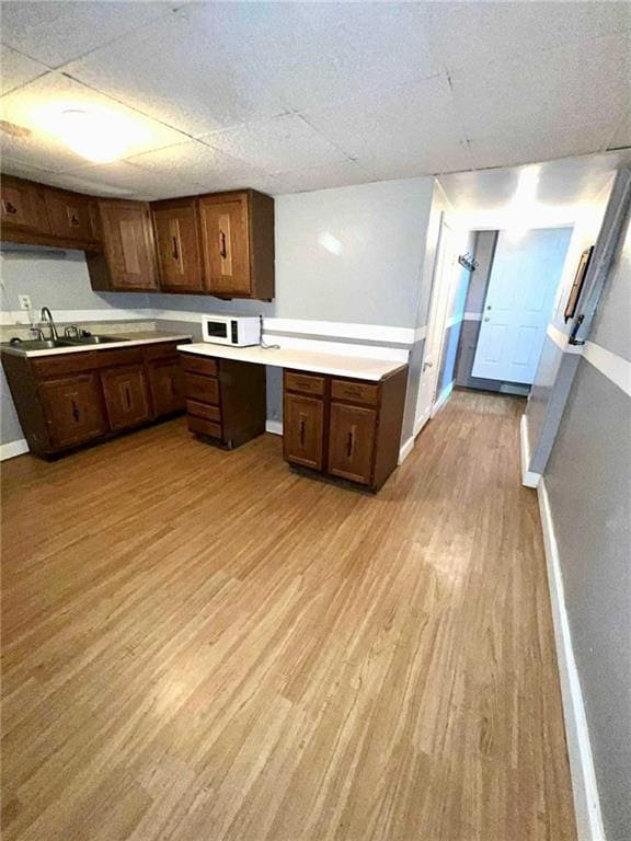 kitchen featuring light wood-type flooring and sink