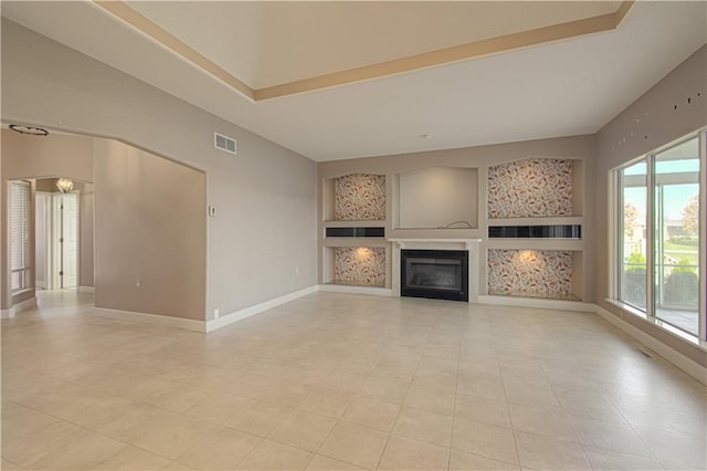 unfurnished living room featuring a raised ceiling