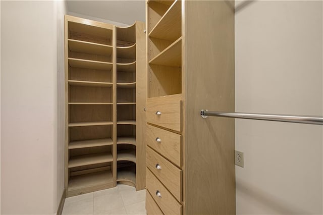 spacious closet featuring light tile patterned floors