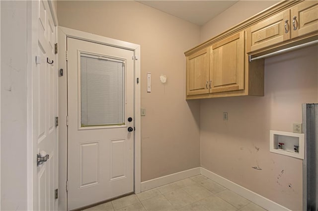 laundry room with cabinets, washer hookup, and light tile patterned floors