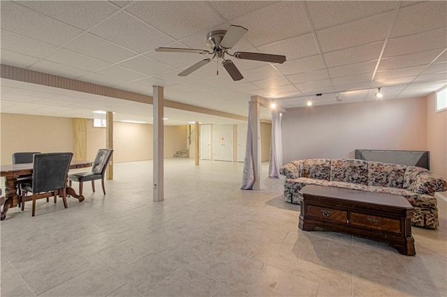 interior space featuring a paneled ceiling and ceiling fan