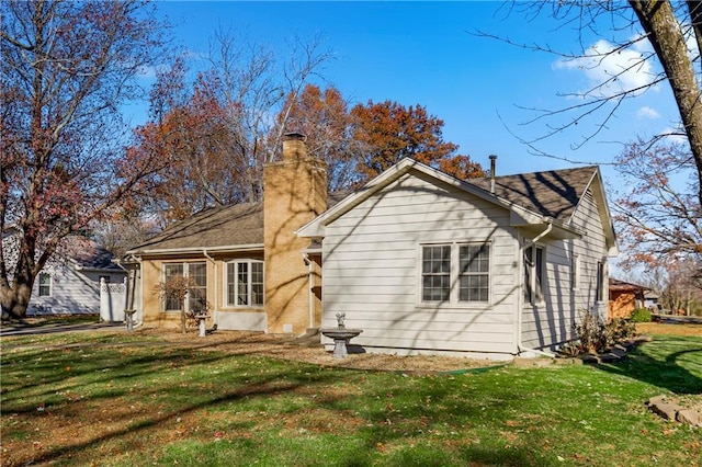 back of property featuring a lawn