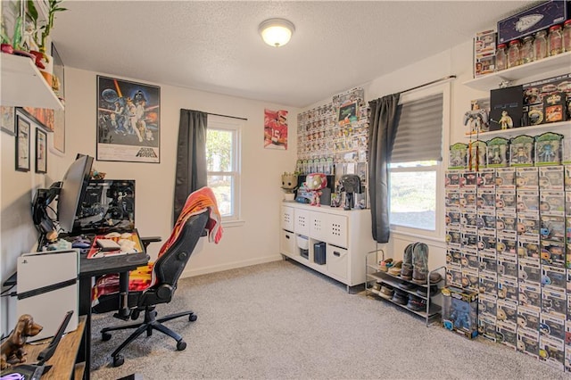 home office featuring light carpet and a textured ceiling