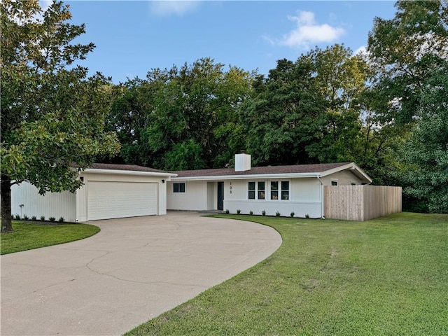 single story home with a garage and a front lawn