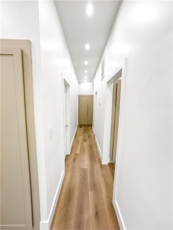 corridor with light hardwood / wood-style flooring