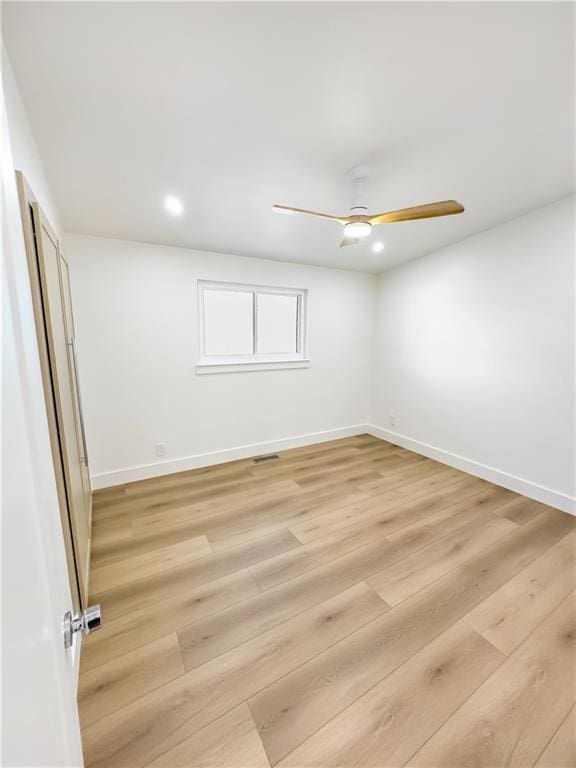 spare room featuring ceiling fan and light wood-type flooring