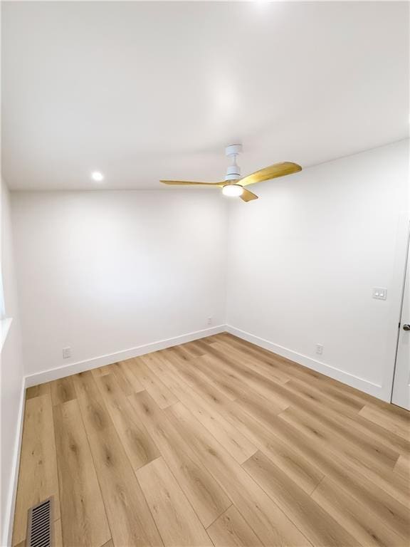 empty room featuring ceiling fan and light hardwood / wood-style flooring