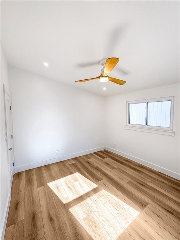 unfurnished room featuring ceiling fan and light hardwood / wood-style floors