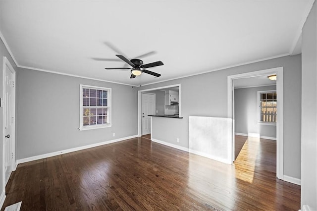 empty room featuring ceiling fan, dark hardwood / wood-style flooring, and ornamental molding