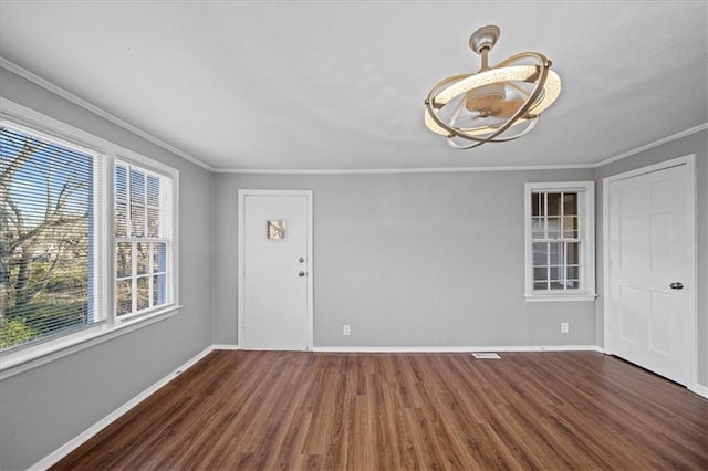 unfurnished room with crown molding and dark wood-type flooring