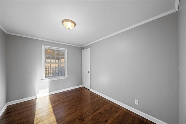 spare room with dark hardwood / wood-style flooring and ornamental molding