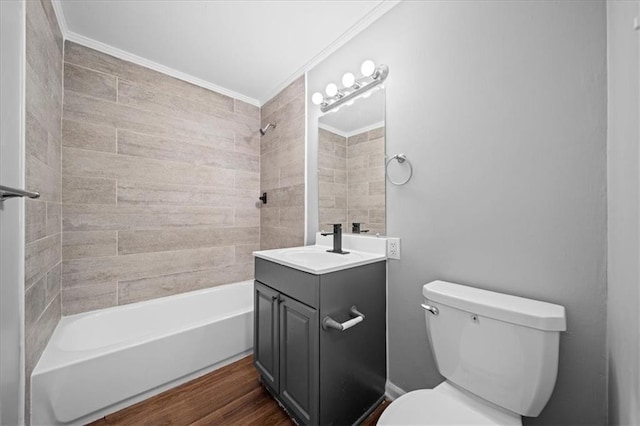 full bathroom featuring vanity, crown molding, tiled shower / bath, toilet, and wood-type flooring