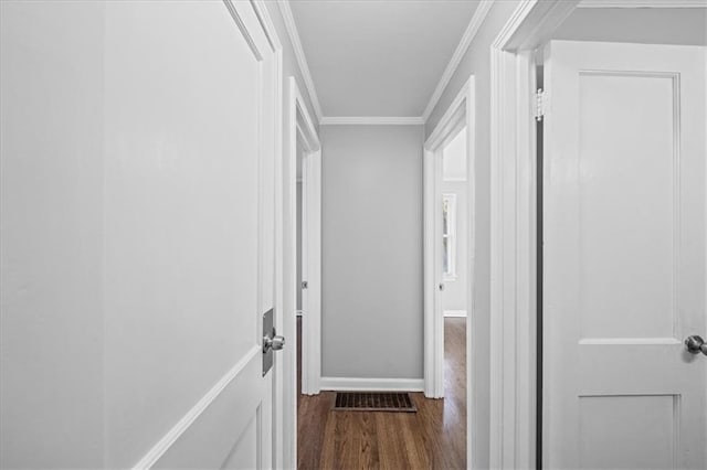 hall featuring crown molding and dark hardwood / wood-style floors