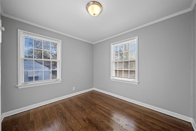 empty room with dark hardwood / wood-style flooring and crown molding