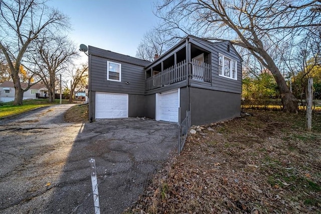 view of home's exterior with a balcony and a garage