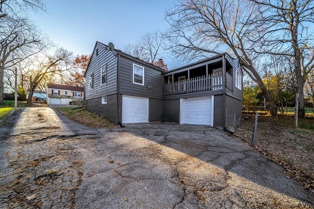 exterior space with a garage and a balcony