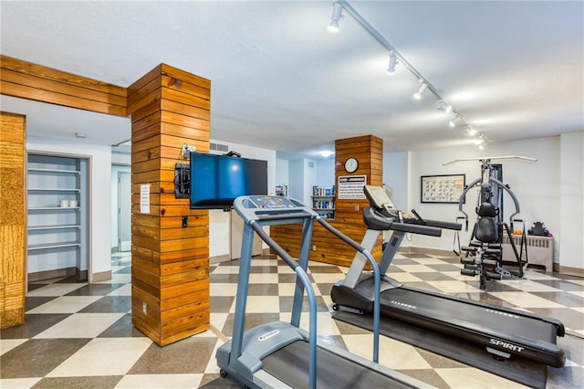 workout room featuring rail lighting