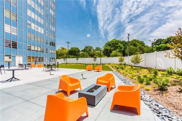 view of community with a patio and a fire pit