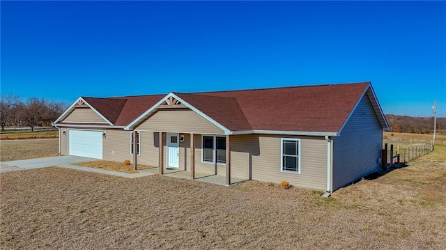 single story home featuring covered porch and a garage