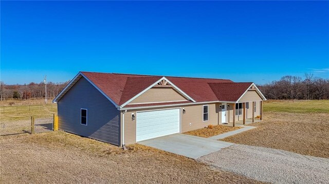 815 SW 520th Rd, Holden, MO 64040 - view of front of house with concrete driveway, a garage, and a porch