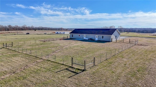 view of yard with a rural view and an outdoor structure