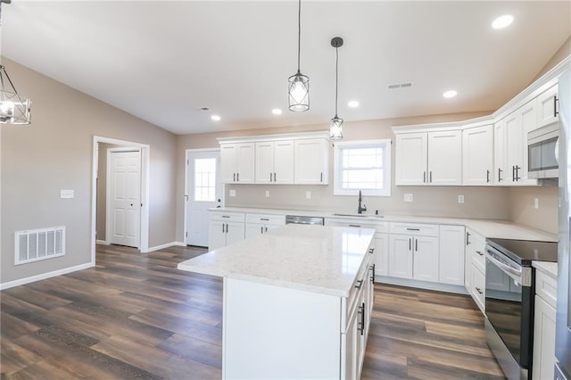 kitchen with a healthy amount of sunlight, white cabinets, and stainless steel appliances