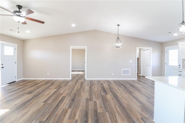 815 SW 520th Rd, Holden, MO 64040 - unfurnished living room with vaulted ceiling, wood finished floors, a ceiling fan, recessed lighting, and a chandelier