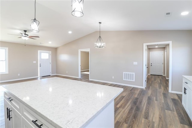 815 SW 520th Rd, Holden, MO 64040 - kitchen featuring open floor plan, dark wood-type flooring, ceiling fan, decorative light fixtures, and white cabinetry