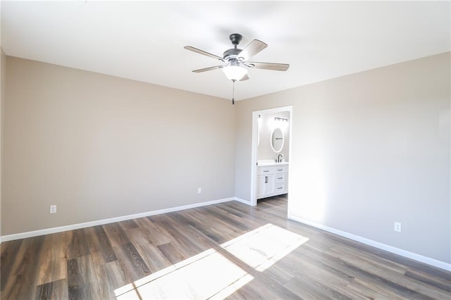 empty room with ceiling fan, sink, and dark hardwood / wood-style floors