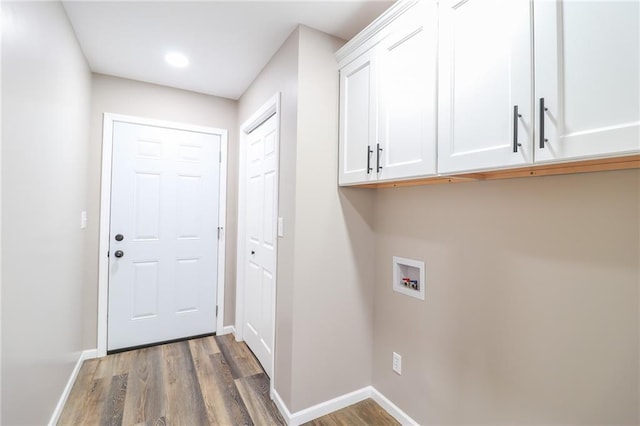 washroom featuring cabinets, hookup for a washing machine, and hardwood / wood-style flooring