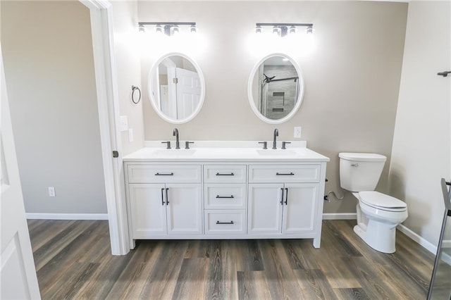 bathroom with vanity, toilet, and wood-type flooring